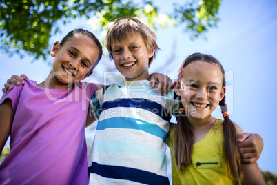 Portrait of happy children standing together in park