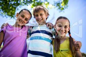 Portrait of happy children standing together in park