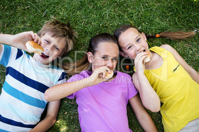 Portrait of children eating bun