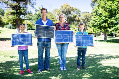 Family holding a solar panel