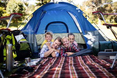 Happy family lying in a tent