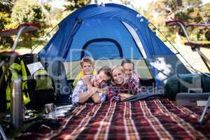 Happy family lying in a tent