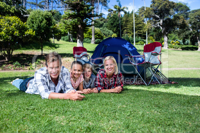 Portrait of happy family lying on grass