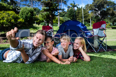 Happy family taking a selfie in the park