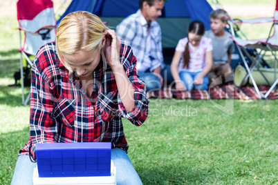 Woman looking into the cool box outside the tent