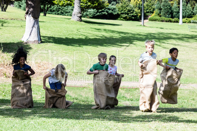 Children having a sack race in park