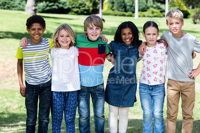 Portrait of happy children standing together in park