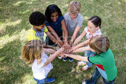 Children putting their hands together