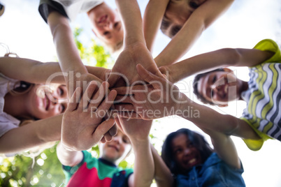 Children putting their hands together