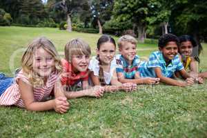 Happy children lying on grass