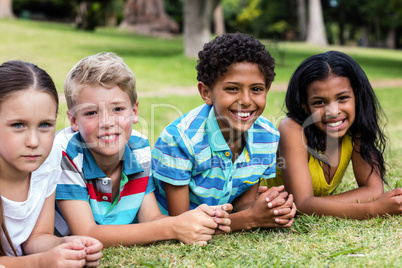 Happy children lying on grass