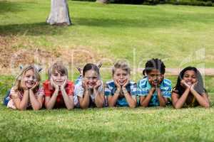 Happy children lying on grass