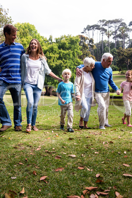 Multi-generation family walking in the park