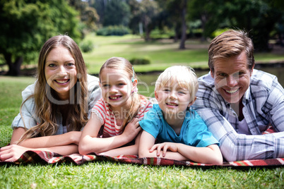 Happy family lying in the park