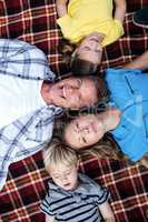 Family lying together in the park