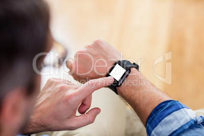 A man is touching his watch
