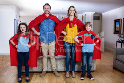 Portrait of a family pretending to be superhero in living room