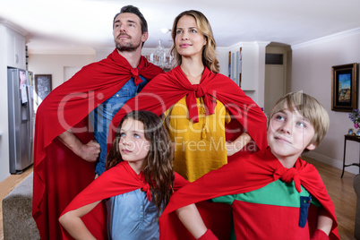 Family pretending to be superhero in living room