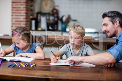 Father helping kids with their homework