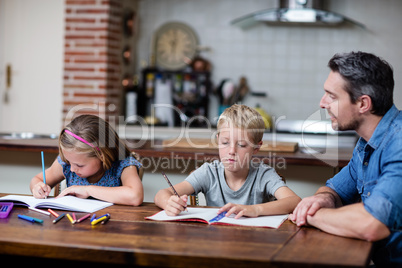 Father helping kids with their homework