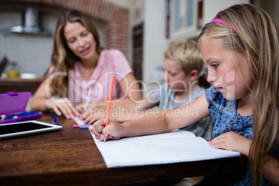 Mother helping kids with their homework