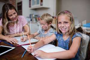 Mother helping kids with their homework