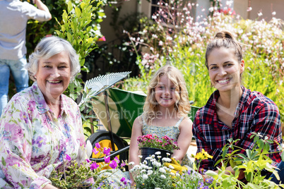 Portrait of grandmother, mother and daughter gardening together