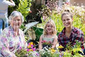 Portrait of grandmother, mother and daughter gardening together