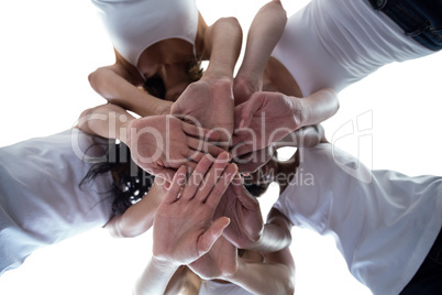 Women in a circle putting their hands together