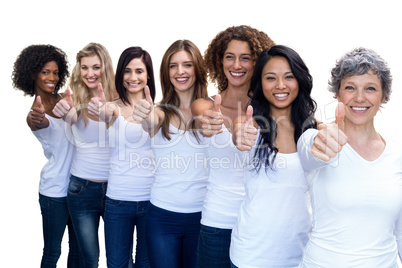 Happy multiethnic women standing in a line and showing thumbs up