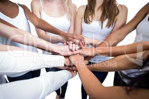 Women in a circle putting their hands together