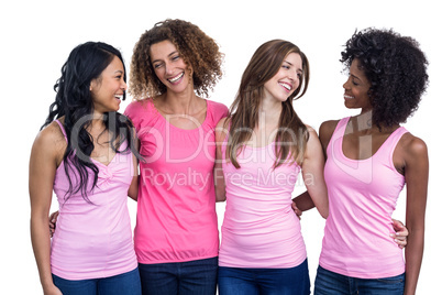 Smiling women in pink outfits standing together