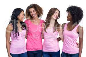 Smiling women in pink outfits standing together