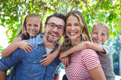 Happy parents giving piggy back to children