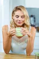 Relaxed young woman having coffee at home