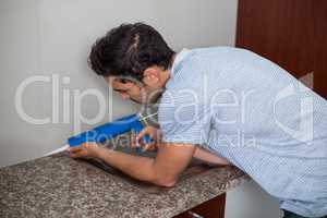Side view of man using pest control injection