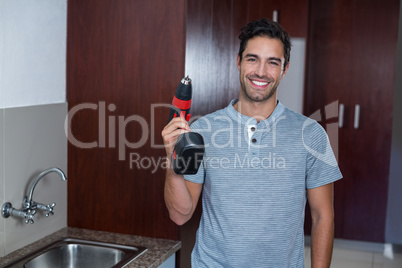 Happy man holding cordless hand drill