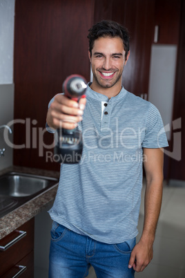 Portrait of smiling man holding cordless hand drill