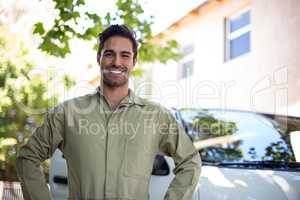 Portrait of smiling pesticide workerwith hand on hip