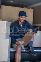 Smiling delivery person with clipboard