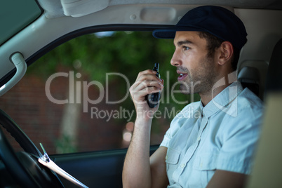 Delivery man using walkie-talkie