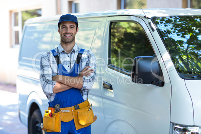 Portrait of happy carpenter with arms crossed