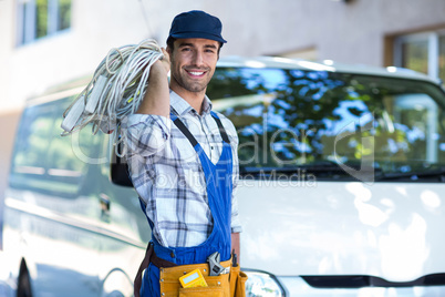 Portrait of happy carpenter with wire