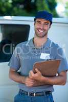 Smiling delivery person holding clipboard