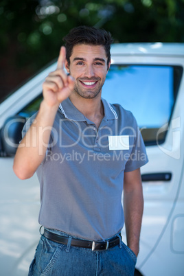 Portrait of happy delivery person gesturing