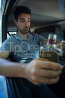 Slumped man with alcohol bottle