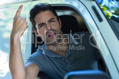 Portrait of irritated young man pointing