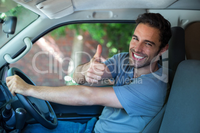 Portrait of happy man showing thumbs up