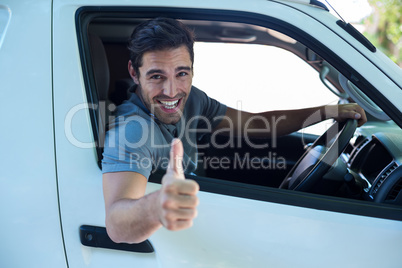 Portrait of cheerful man with thumbs up sign