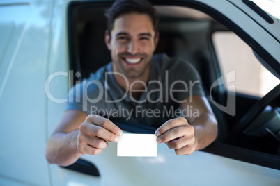 Smiling driver man showing blank card